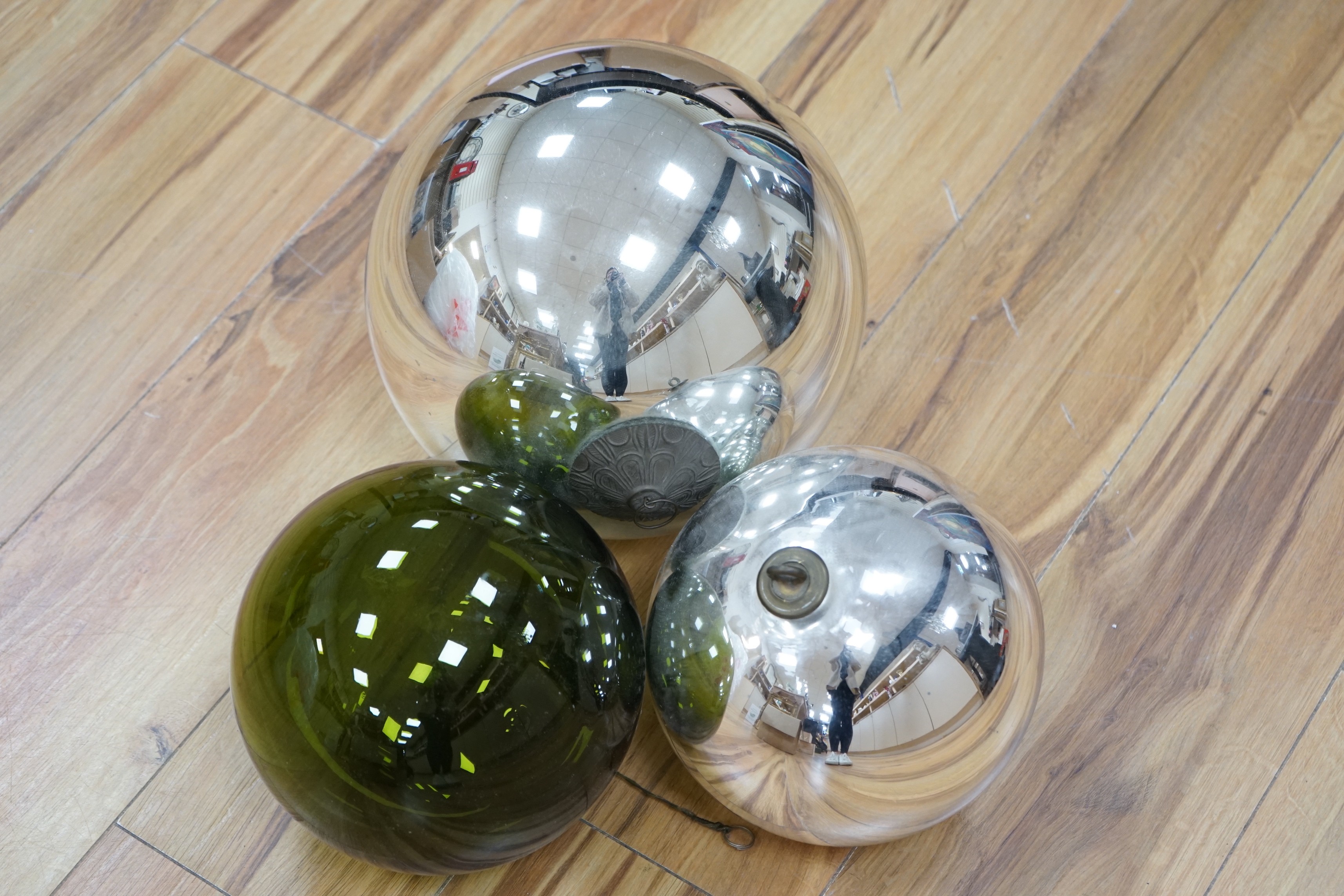 Two silvered glass witches balls and another